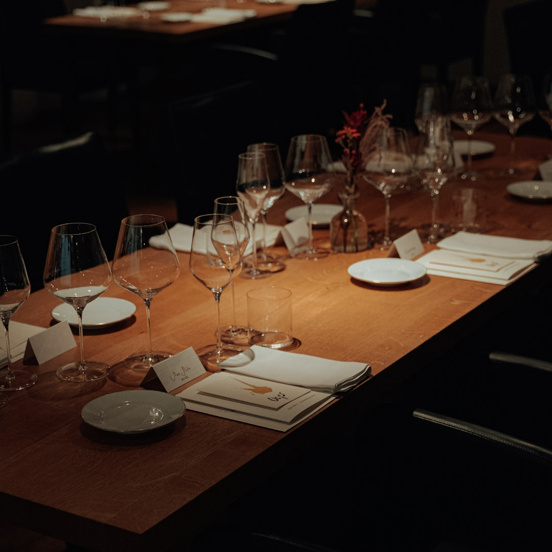 Mesa preparada com taças e menus para o jantar em Modena